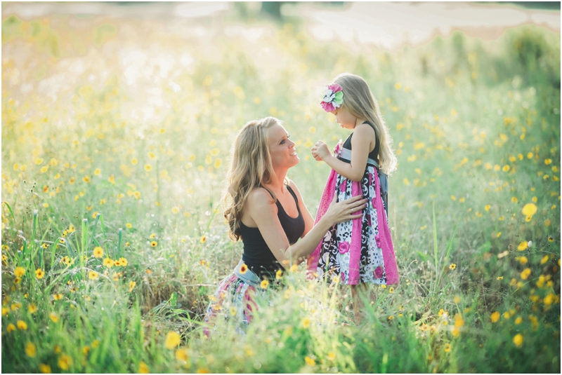mom and daughter in yellow flower field